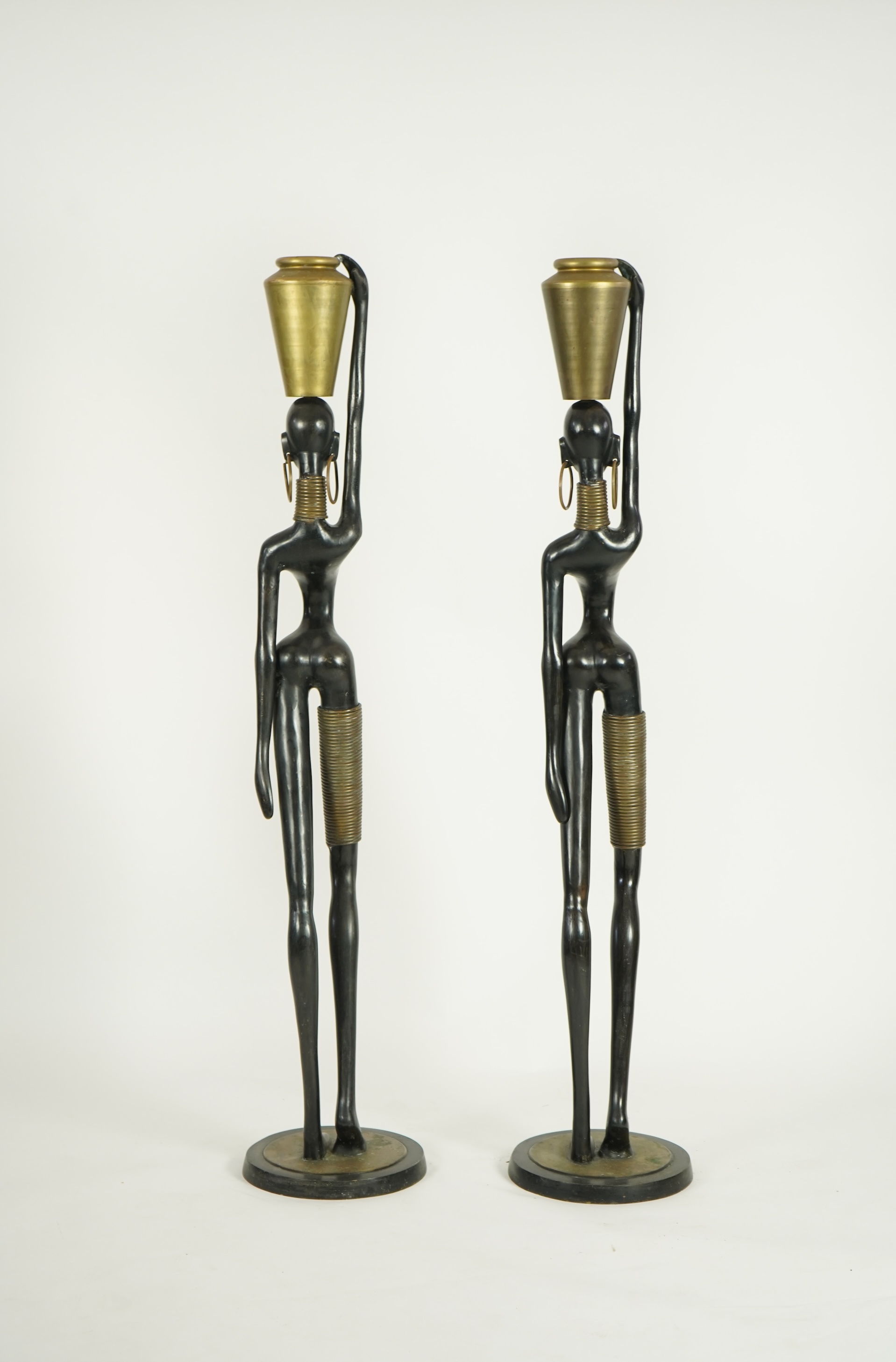 A large pair of Hagenauer style ebonised bronze 'Giraffe Woman' figures
